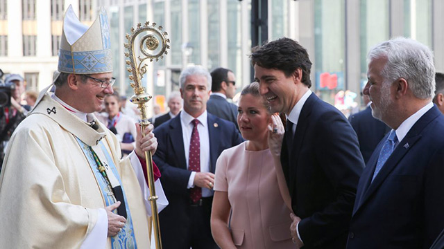 Archbishop Christian Lepine of Montreal smiles as he greets Canadian Prime Minister Justin Trudeau before the ceremonial Mass May 17 at Notre-Dame Basilica in Montreal for the city's 375th birthday