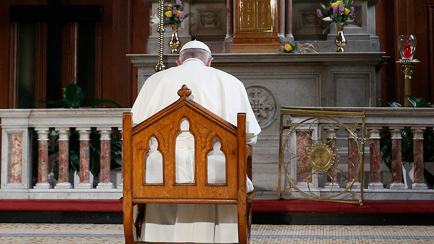 Pope Francis prays in front of a candle in memory of victims of sexual abuse as he visits St. Mary's Pro-Cathedral in Dublin Aug. 25, 2018. 