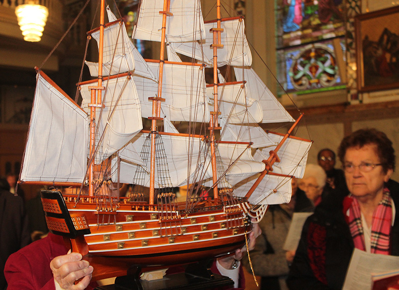 CND congregational leader Sr. Agnes Campbell carries scale-model ship symbolizing the many journeys made to fulfill Ville Marie’s mission of love and proclamation. (Photo: Eric Durocher)