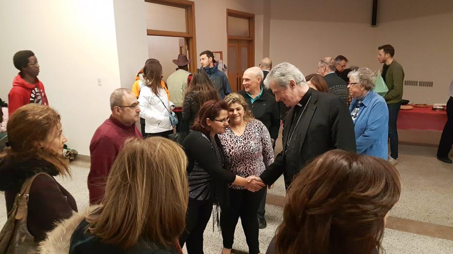 Msgr. Lépine welcoming one refugee family from Syria. 