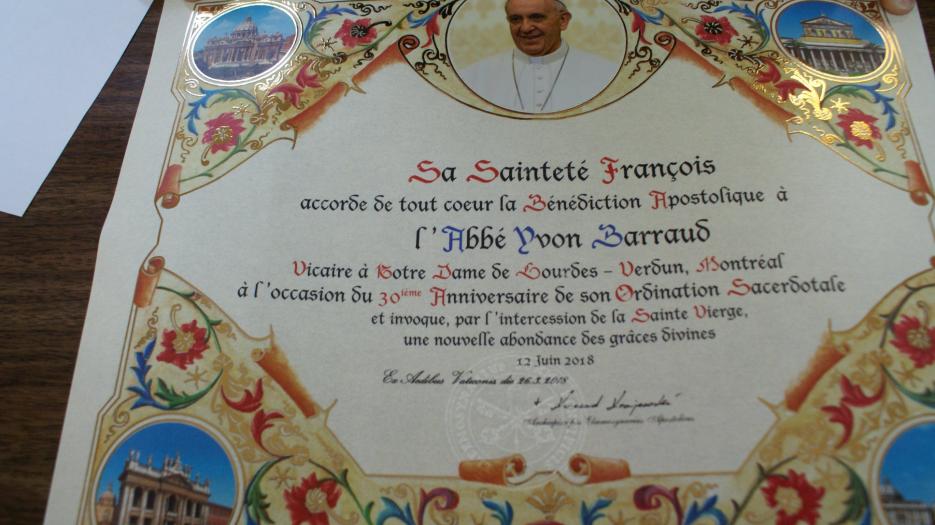 L’Abbé Yvon Barraud était fier d’exhiber la bénédiction apostolique du pape François. (Photo : Brigitte Bédard)