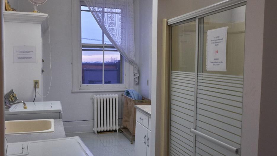 A small laundry room and shower for the residents. (Photo: Richard Maltais)