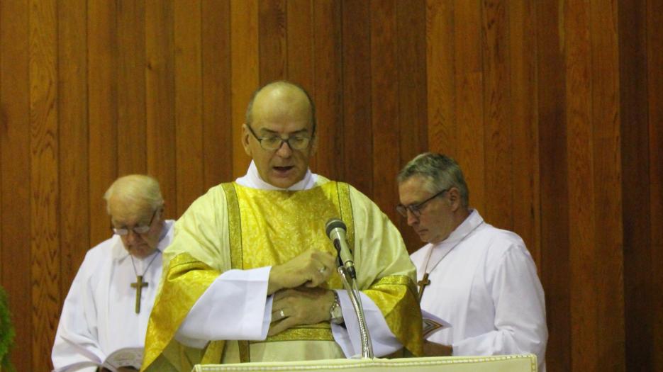 Permanent deacon Alain Normand proclaims the Gospel